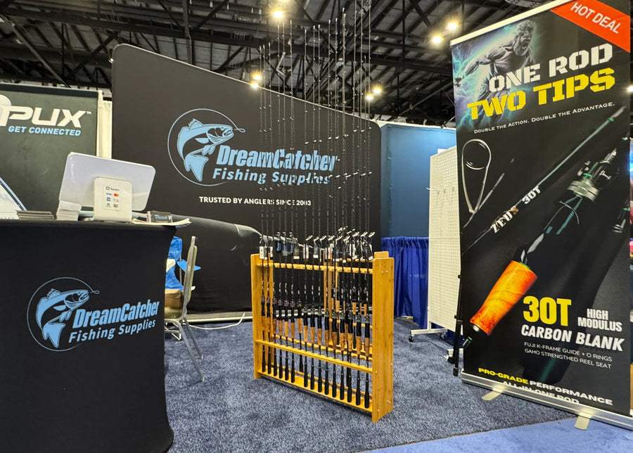 Fishing rods with dual tips displayed at trade show booth, featuring 30T carbon fiber design.