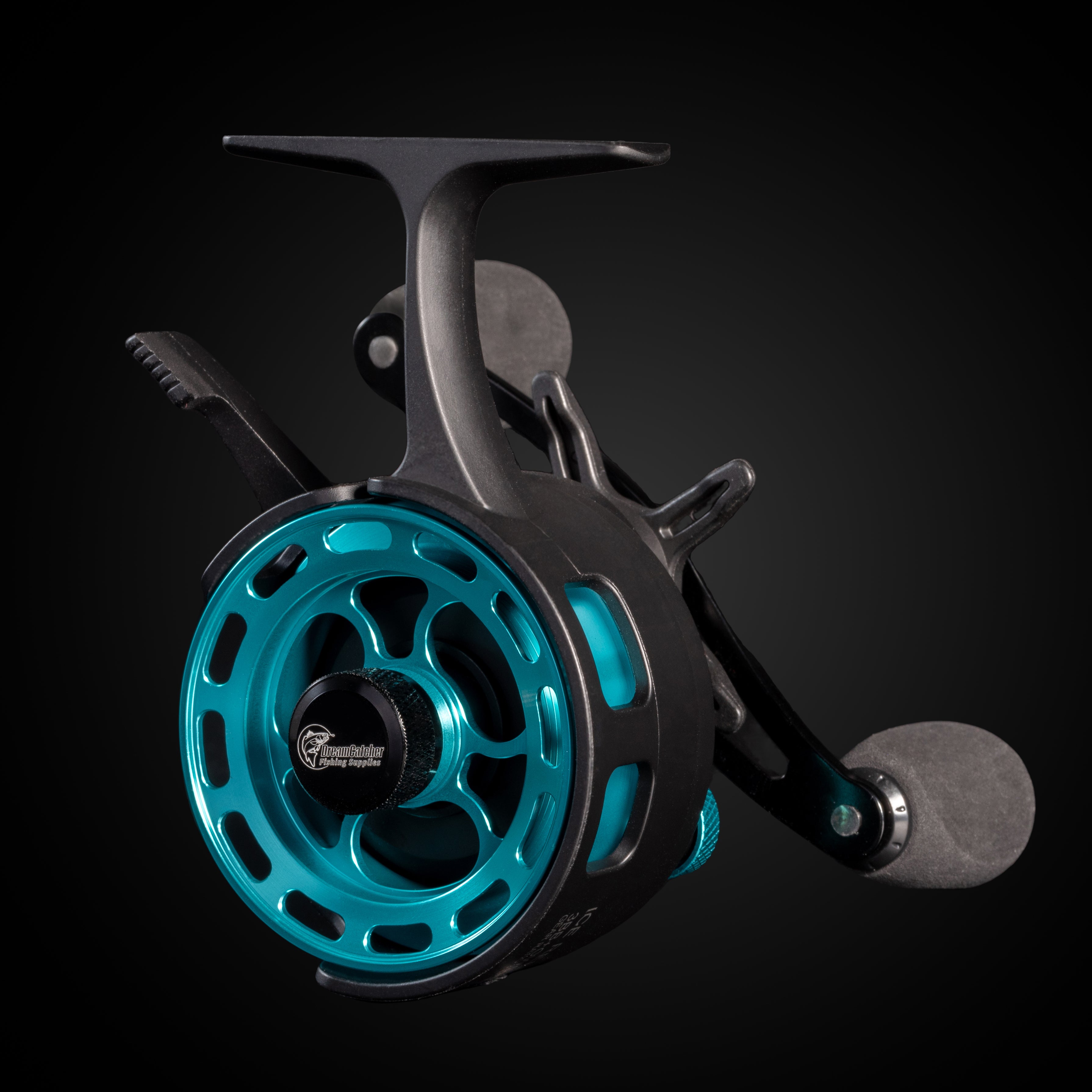 ice fishing reel with metallic blue spool and black handle on dark background